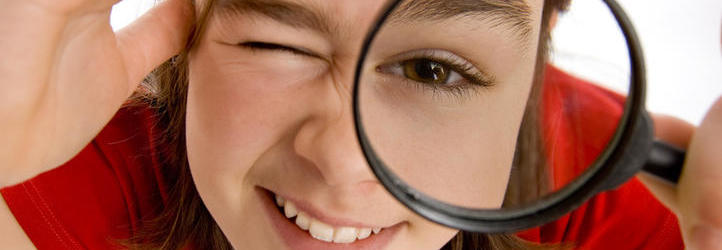 Girl holding magnifying glass